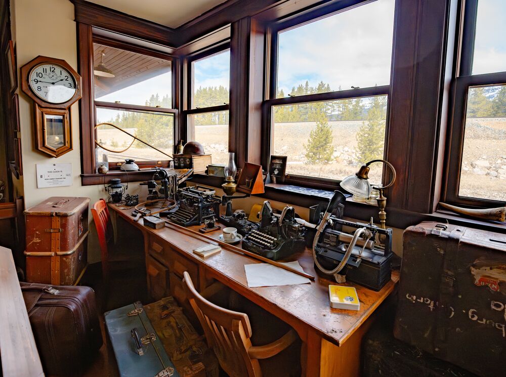 The Station Restaurant in Lake Louise Master Room with vintage desk, morse code machine, and historic railway artifacts